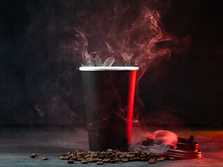 Küchenrückwand glas motiv Kaffee und Kaffeebohnen Hot coffee in a paper cup on a black background. Steam from a hot drink  © pavelkant