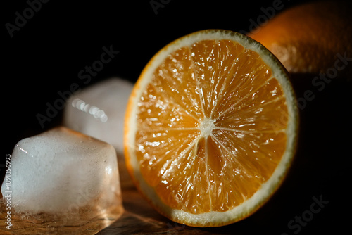 Lemon slice and ice cubes with blue and orange neon lighting