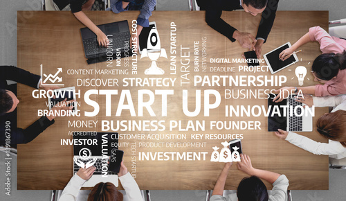Εκτύπωση καμβά A diverse group of individuals engages in a collaborative startup brainstorming session, discussing innovative strategies and business plans over a wooden table filled with ideas