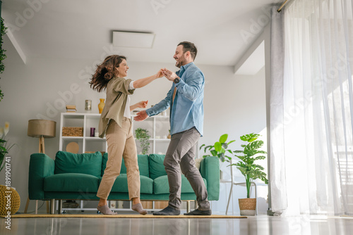 Canvas Print Happy couple dancing enjoying loving moments at home