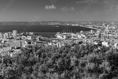 Panoramic aerial view od Marseille old port and its Mediterranean coastline; famous travel landmark city skyline of Marseille, Provence, France in black and white