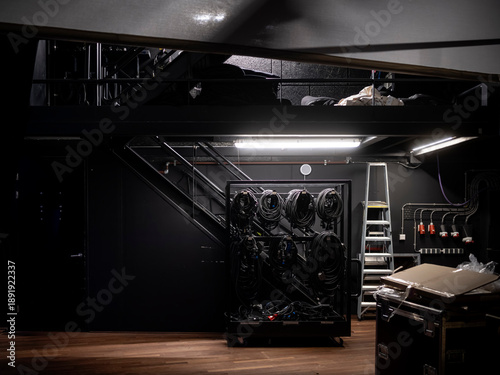 Картината върху платно Wide view of theatre backstage area with cable racks, metal stairs, ladder, powe