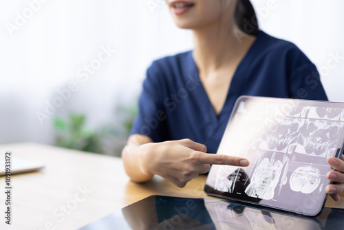 Принти на полотні X-ray Image on Digital Tablet Explained by Female Healthcare Worker
