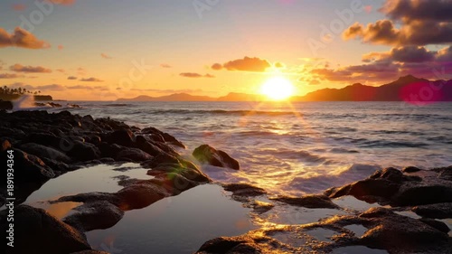 Scenic sunset over rocky coastline with waves crashing onto the shore during a beautiful golden hour