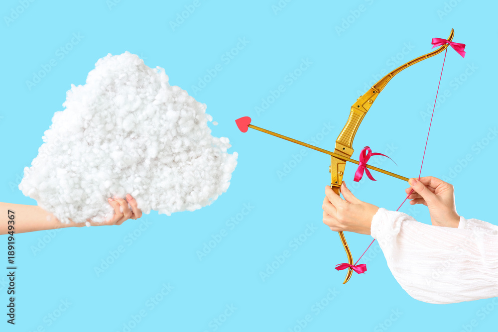 Fototapeta premium Female hands with cupid's bow and decorative cloud on color background. Valentine's Day celebration