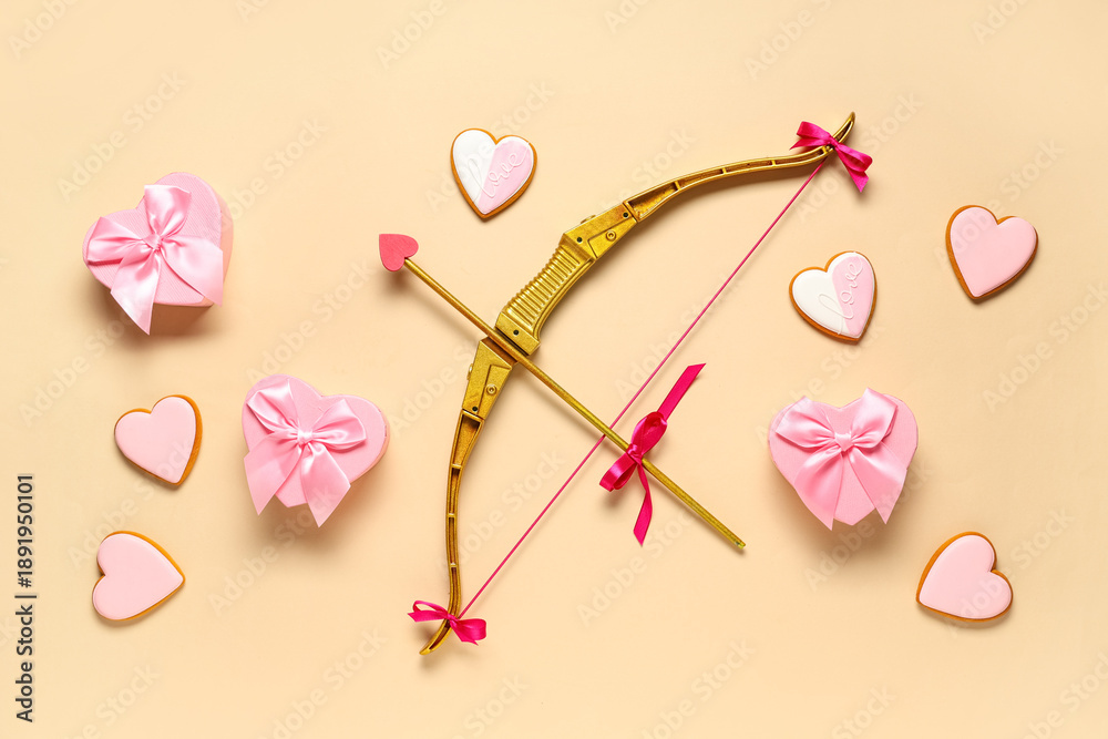 Fototapeta premium Composition with cupid's bow and heart shaped cookies on color background. Valentine's Day celebration