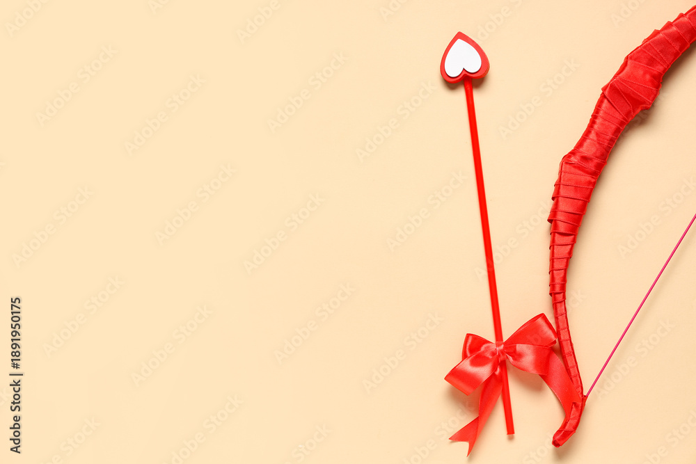 Obraz premium Red cupid's bow on color background. Valentine's Day celebration