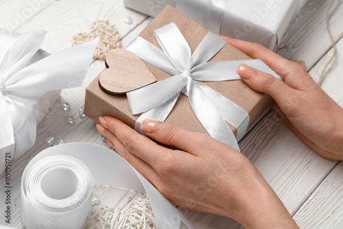 Female hands with gift boxe...