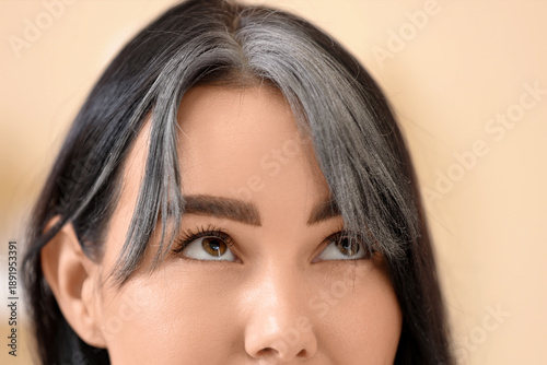 Young woman with graying ha...