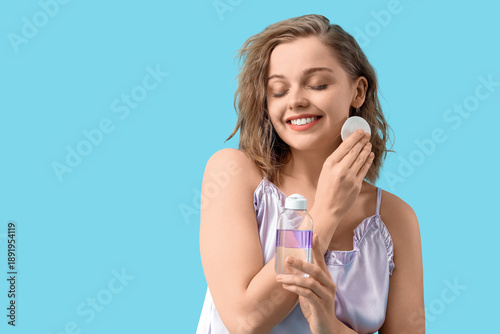 Young woman with bottle of ...