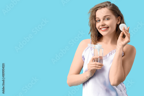 Young woman with bottle of ...