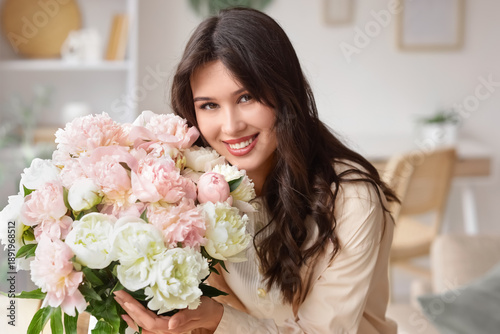 Young woman with bouquet of...
