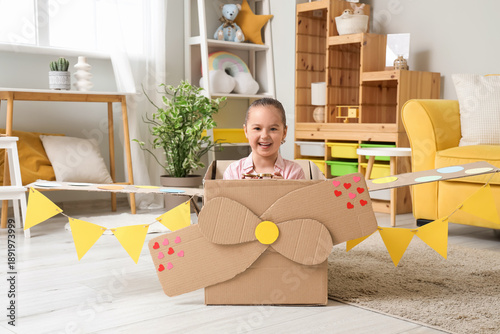 Cute little girl in cardboa...