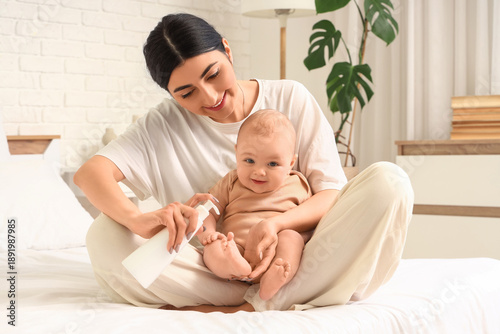 Happy mother applying cream...