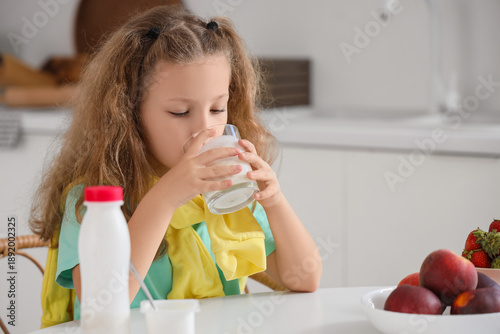 Cute little girl with glass...
