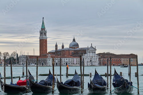 Photography San Giorgio Maggiore church and bell tower seen from Venice with gondolas, Italy