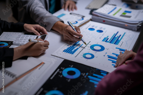 Business people analyzing financial data charts in meeting