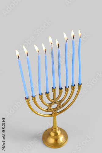 Menorah with burning candle...