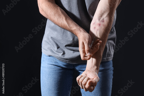 Male drug addict making inj...