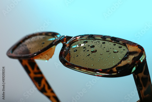 Cuadro en lienzo Stylish sunglasses on turquoise background, closeup