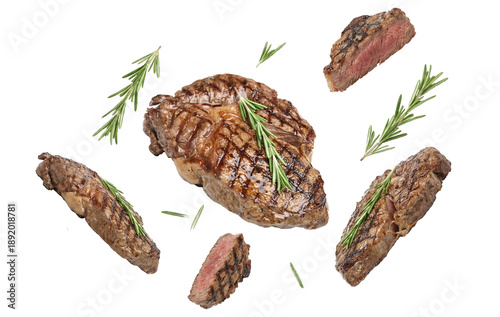 Tableau sur toile artistic food photography featuring a perfectly grilled ribeye steak centerpiece with rosemary sprigs and scattered peppercorns on a dark background, evoking a sense of premium dining