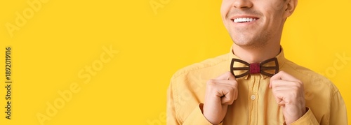 Smiling young man adjusting...