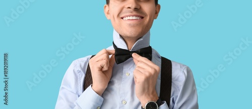Happy young man putting on ...