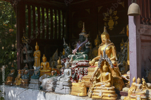 Photography Spiritual collection of gold buddha statue figures at religious shrine in temple