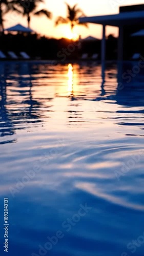 Wallpaper Mural Circular ripples in tranquil blue water reflecting a blurred golden sunset glow Torontodigital.ca