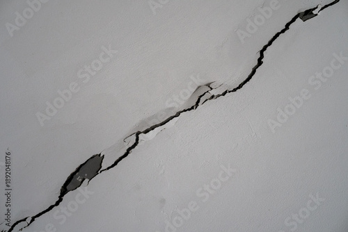 Large Diagonal Crack in Grey Concrete Wall Structure