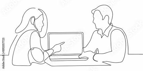 Two people discussing work while looking at a laptop computer