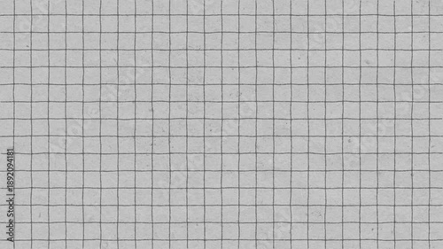 A high angle shot of textured grid paper surface ready for notes and calculations.
