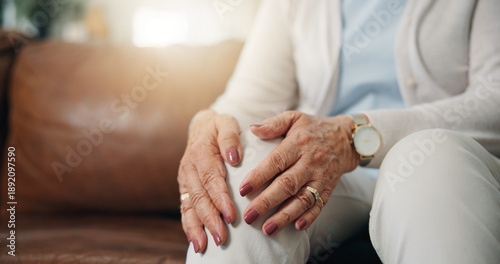 Photos Hands, knee pain and senior person on sofa in living room of home for arthritis condition or symptoms