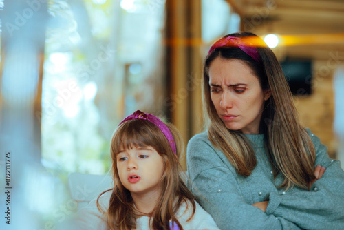 Angry Mom Looks at Her Child as She Argues being Rude. Frustrated mother observes her daughter during a disrespectful confrontation 
