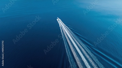 hydrofoil. Aerial view of a white wake trail on a calm blue sea. travel magazines, destination branding, wall prints, designed for travel destination branding, used by customer success managers.