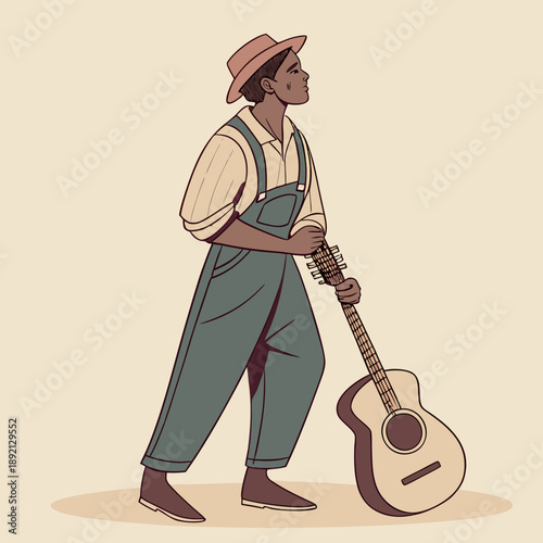 Man in overalls holding acoustic guitar and wearing a hat