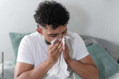 Tableau sur toile Sick man blowing nose suffering from flu symptoms