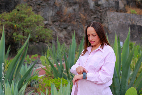 Pregnant woman adjusts her smartwatch