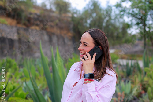 A Smiling pregnant woman makes a call on her cell phone