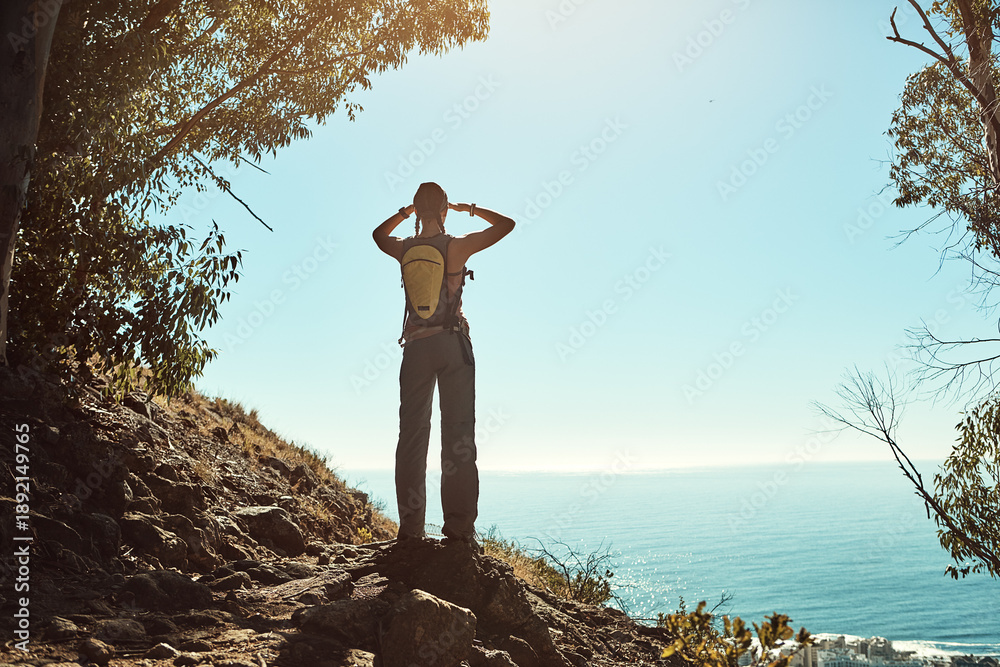 Fototapeta premium Hiking, ocean and back of woman with view on mountain for travel, adventure and sightseeing in nature. Trekking, scenery and person with space for eco tourism, hobby and holiday trip in countryside