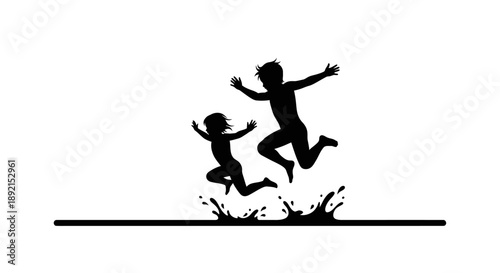 Silhouette of two children jumping in a puddle, creating a splash of water.