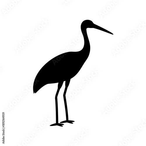 Elegant black silhouette of a crane standing tall and serene against white