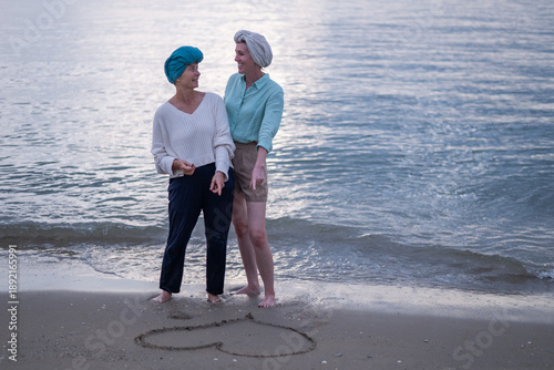 Fotografie Moment friend support resilience and compassion, often associated with of battling cancer wearing a headscarf a common symbol of strength among cancer patients undergoing treatment