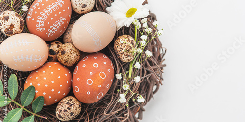 Canvas Print Easter nest with hand-painted eggs and quail eggs on a light background