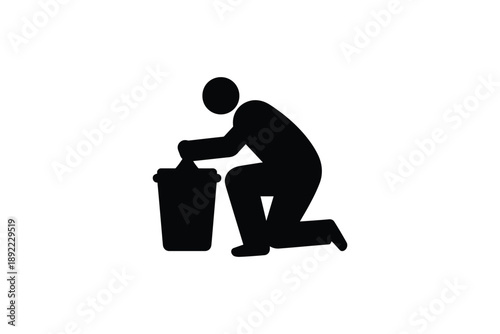 Man kneeling to dispose of garbage in a trash can, demonstrating proper waste management