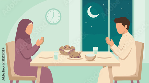 Muslim couple praying at home before breaking fast (Iftar) during Ramadan