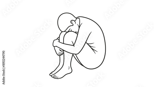 Depressed person sitting on floor with head in knees