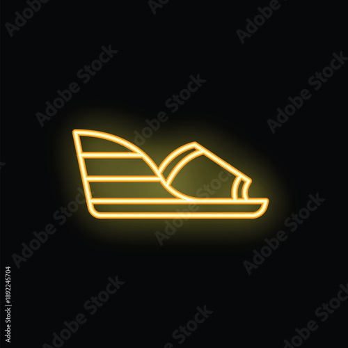 Neon sign depicting a wedge sandal with an ankle strap, glowing yellow against a black background