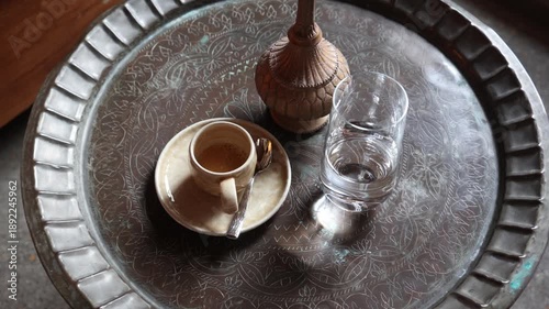 Still Life with Coffee, Water, & Decorative Carafe on a Metal Tray Table, Overhead Shot