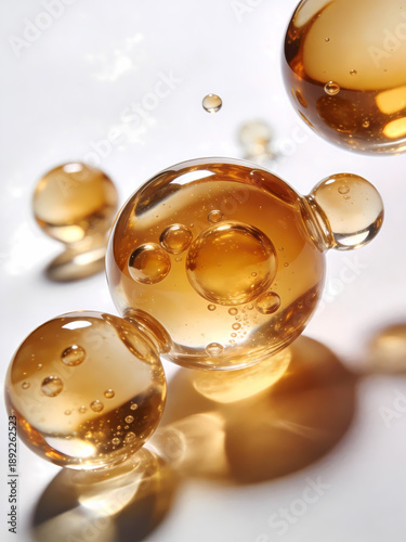 Transparent amber liquid spheres with internal bubbles, close-up. Likely representing skincare serums, vitamins, or cosmetic products. Highlight texture, light reflection, and scientific precision.